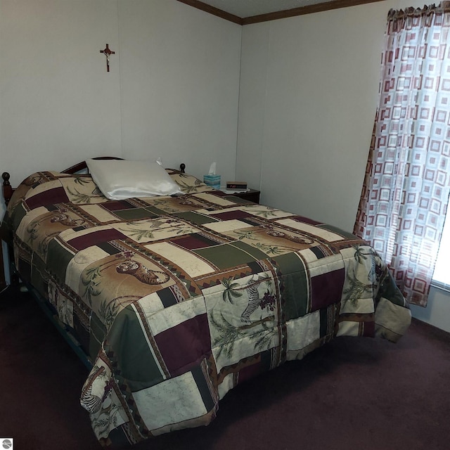 bedroom with dark carpet and ornamental molding