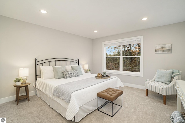 bedroom with recessed lighting, light colored carpet, and baseboards