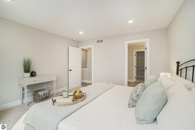 bedroom with light carpet, recessed lighting, visible vents, and baseboards