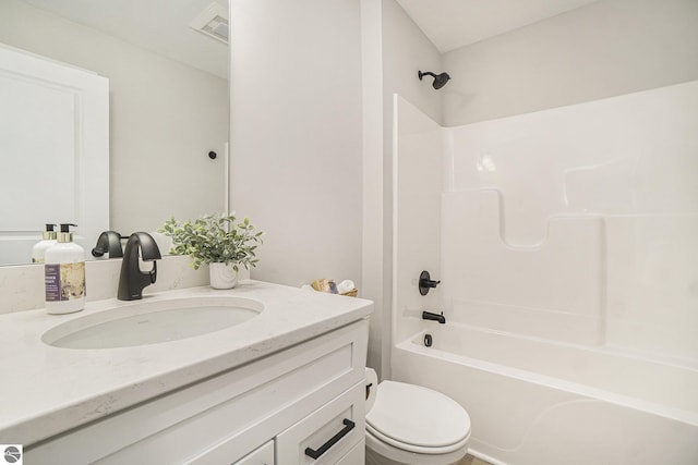 bathroom with toilet, vanity, visible vents, and shower / bathtub combination