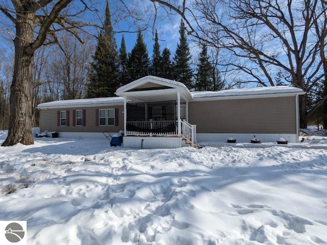 manufactured / mobile home with an attached carport and a porch