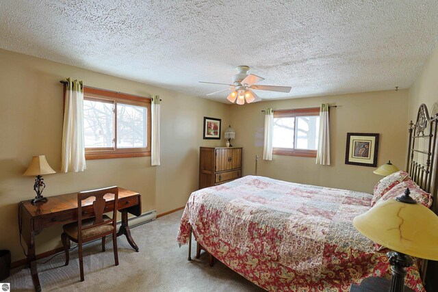 bedroom featuring baseboards, ceiling fan, a textured ceiling, and light colored carpet