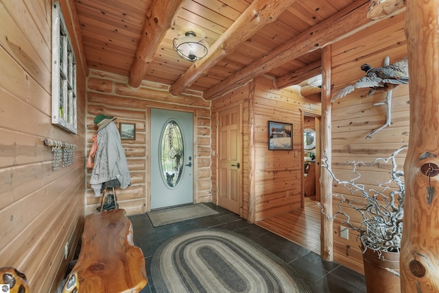 entryway featuring beam ceiling, wooden ceiling, and rustic walls