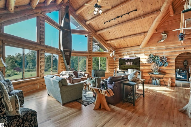 living room featuring wooden ceiling, light wood-style flooring, ceiling fan, and beam ceiling