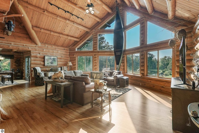 living room with ceiling fan, wooden ceiling, light wood-style flooring, beam ceiling, and track lighting