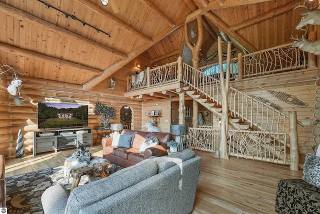 living area with track lighting, wooden ceiling, wood finished floors, high vaulted ceiling, and beam ceiling