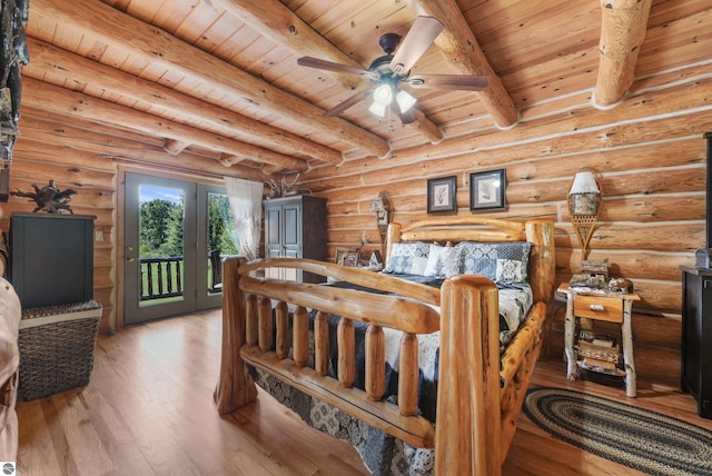 bedroom with access to exterior, beam ceiling, log walls, wood ceiling, and wood finished floors