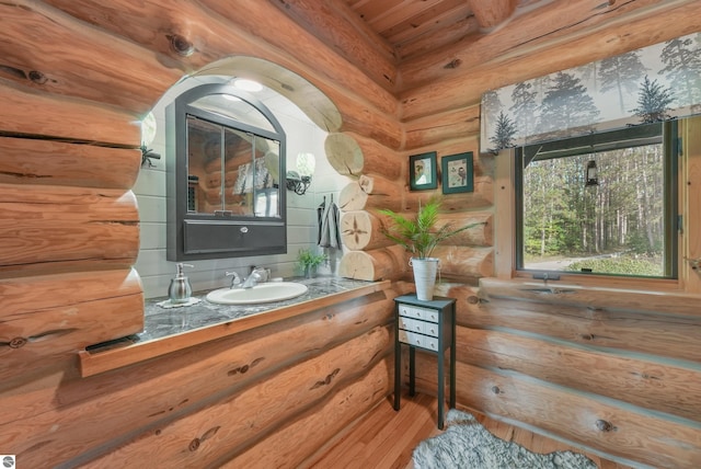 bathroom with log walls and vanity