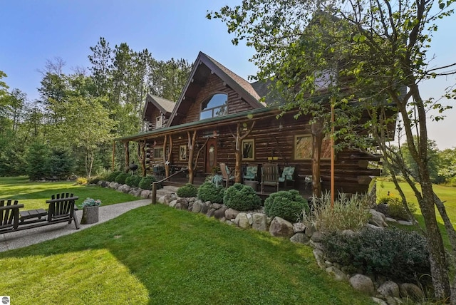 back of property featuring log exterior and a lawn