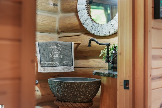 bathroom featuring wood walls