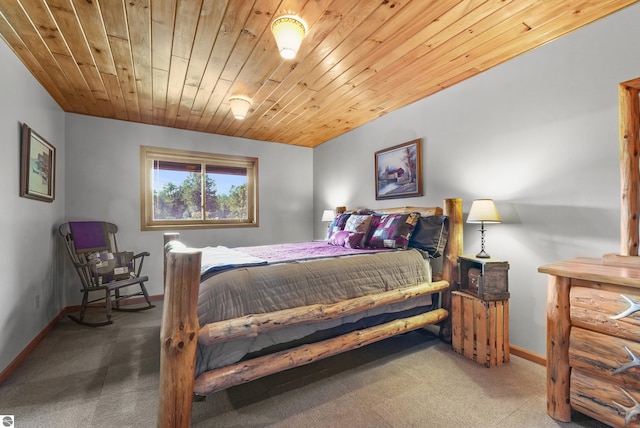 carpeted bedroom with wood ceiling and baseboards