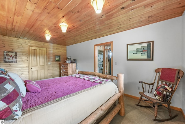 bedroom with wood ceiling, wooden walls, baseboards, and carpet flooring