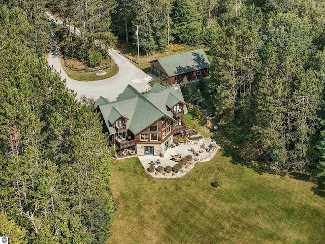 birds eye view of property featuring a view of trees