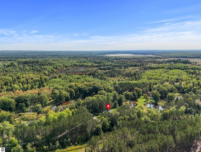 birds eye view of property featuring a view of trees