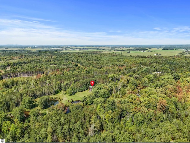 drone / aerial view featuring a forest view