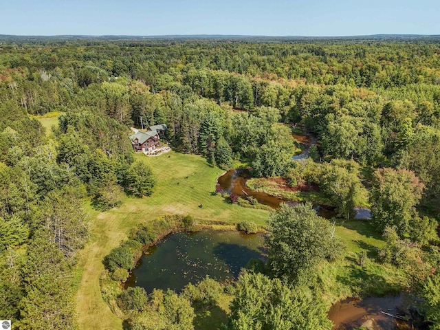 aerial view featuring a water view and a wooded view