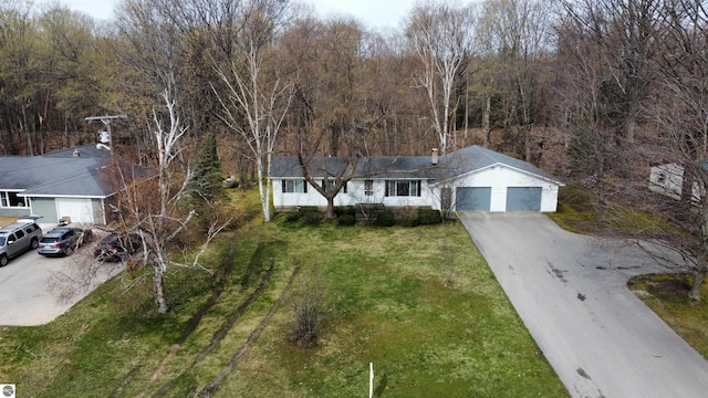 view of front facade featuring a garage, driveway, and a front lawn