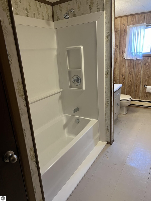 bathroom featuring toilet, baseboard heating, washtub / shower combination, vanity, and tile patterned flooring