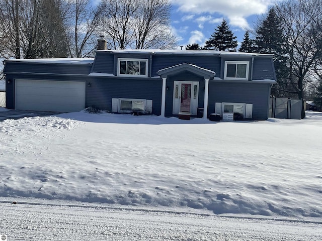 520 Fairlane, Alma, MI 48801 - raised ranch featuring a garage and a chimney