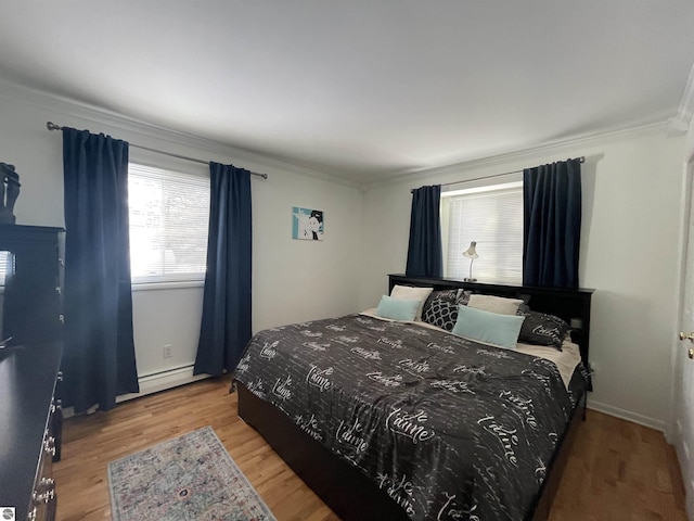 520 Fairlane, Alma, MI 48801 - bedroom featuring baseboard heating, crown molding, and wood finished floors