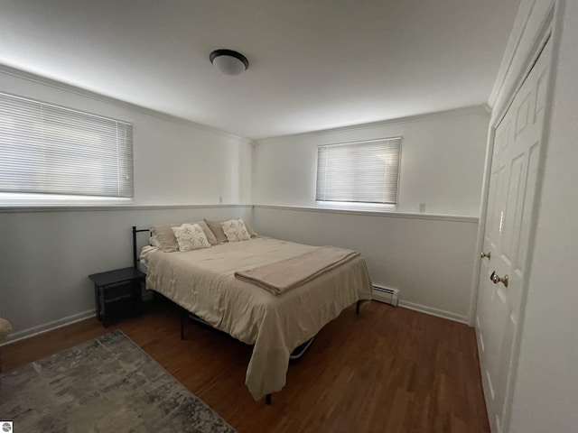520 Fairlane, Alma, MI 48801 - bedroom with baseboard heating, baseboards, ornamental molding, and wood finished floors