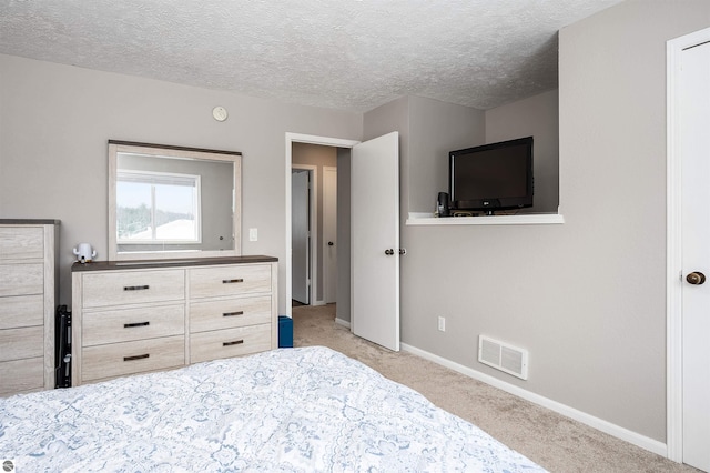 unfurnished bedroom with light carpet, a textured ceiling, visible vents, and baseboards