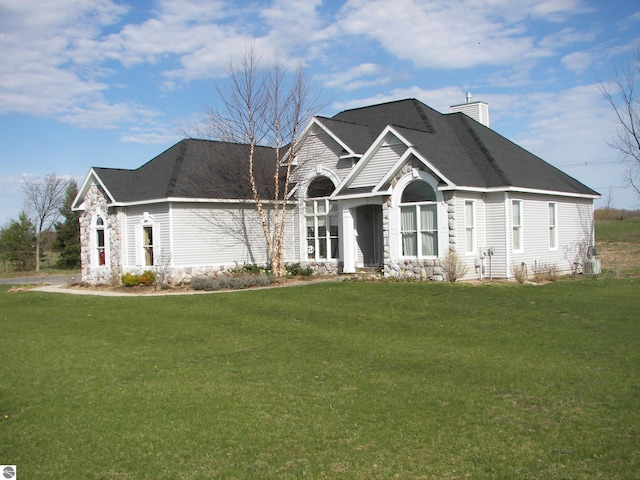 view of front facade with a chimney and a front yard