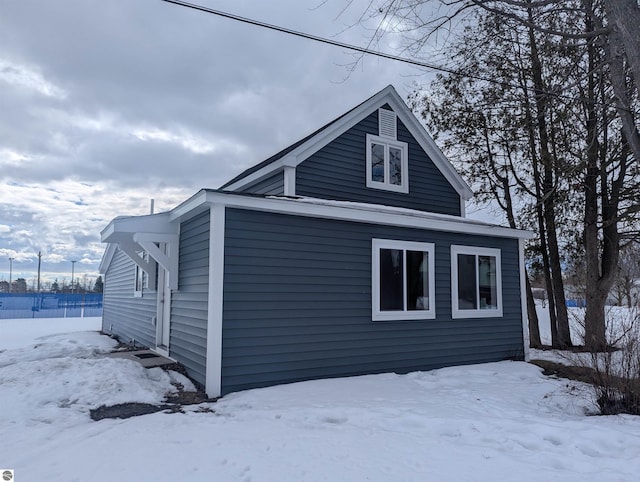 snow covered property featuring a garage