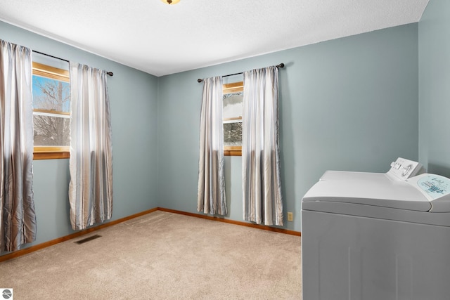 laundry room featuring baseboards, laundry area, visible vents, and light colored carpet