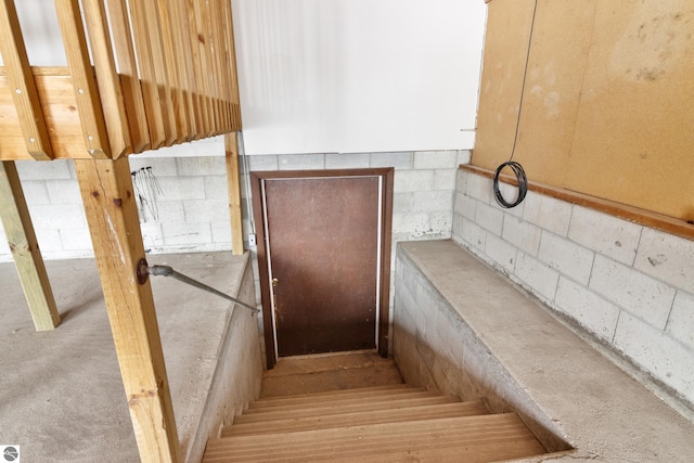 stairway with concrete block wall