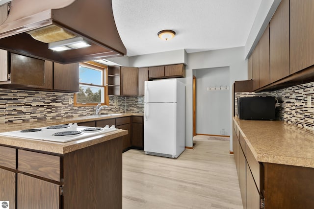 kitchen featuring open shelves, white appliances, island exhaust hood, and light countertops