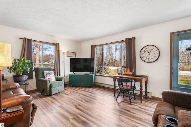 living area featuring a textured ceiling, a baseboard radiator, wood finished floors, baseboards, and baseboard heating