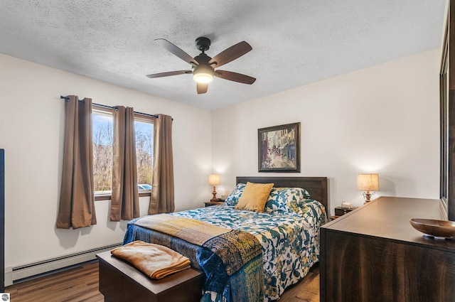 bedroom featuring a baseboard radiator, a textured ceiling, a ceiling fan, and wood finished floors