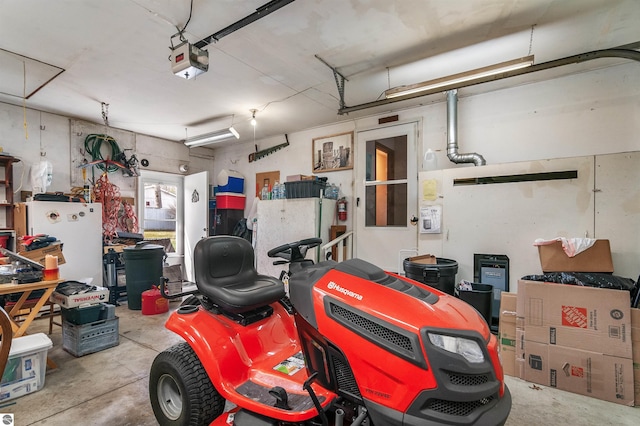 garage featuring a garage door opener and freestanding refrigerator