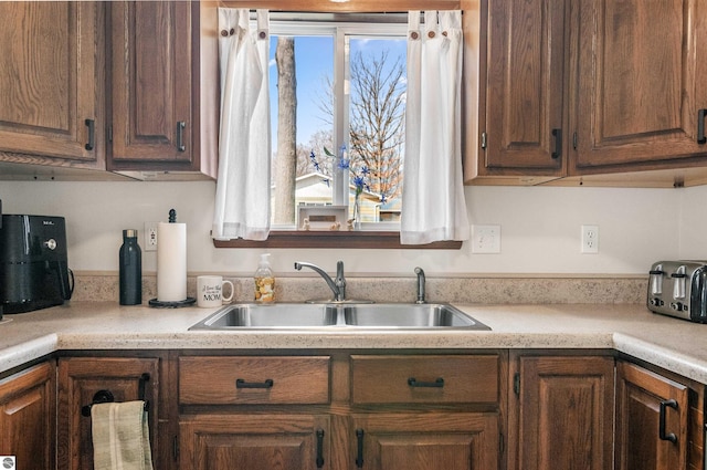 kitchen with light countertops and a sink