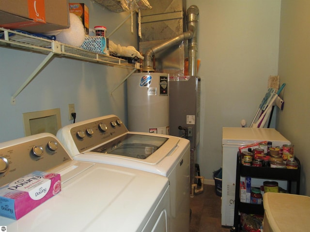 washroom featuring gas water heater, independent washer and dryer, and laundry area