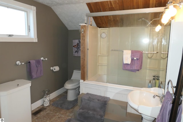 bathroom featuring toilet, a sink, baseboards, vaulted ceiling, and tile patterned floors