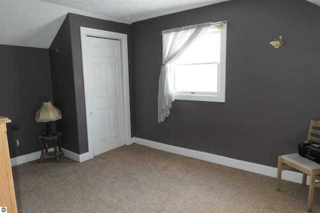 bonus room with baseboards and carpet flooring