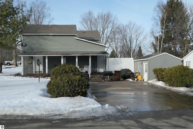 view of front facade with covered porch and an outdoor structure