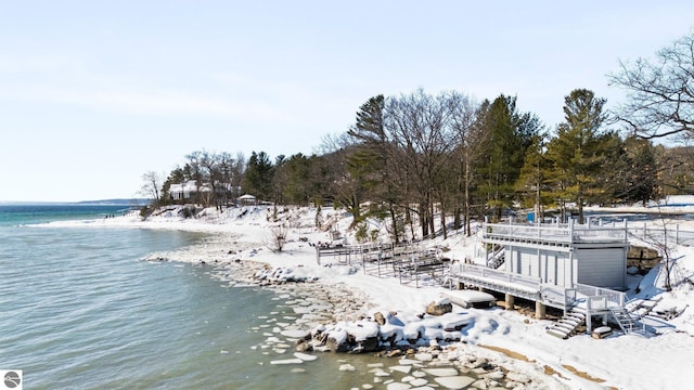 snowy aerial view featuring a water view