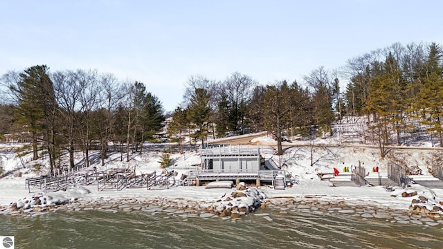 back of property featuring a water view