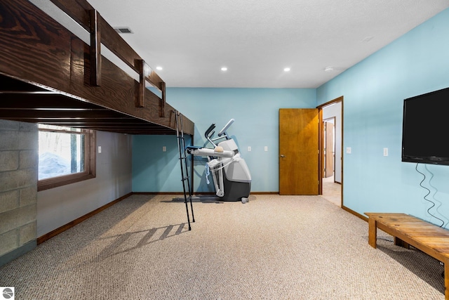 below grade area with light carpet, recessed lighting, visible vents, and baseboards