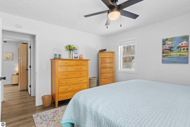 bedroom featuring a ceiling fan and wood finished floors