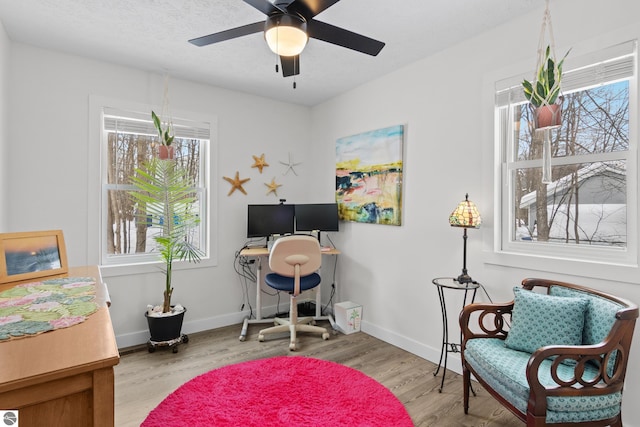 home office featuring ceiling fan, baseboards, and wood finished floors