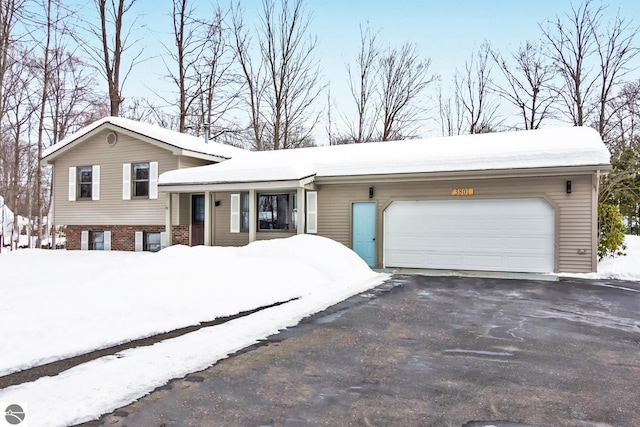 tri-level home featuring brick siding, driveway, and an attached garage