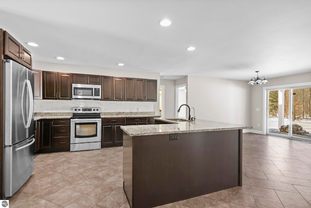 kitchen featuring tasteful backsplash, recessed lighting, appliances with stainless steel finishes, a sink, and dark brown cabinets