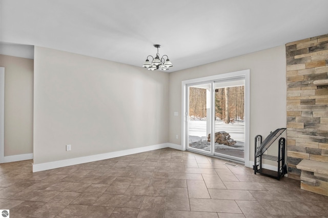 interior space with baseboards and a chandelier