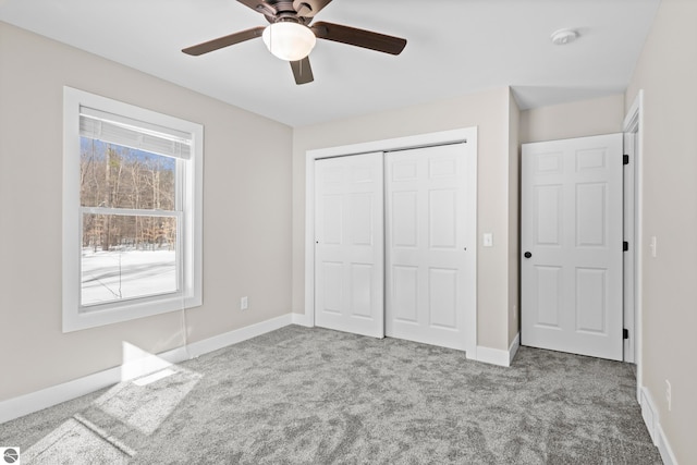 unfurnished bedroom featuring a closet, baseboards, and carpet flooring