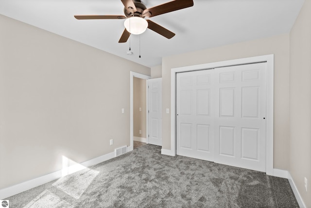 unfurnished bedroom with carpet, a closet, visible vents, ceiling fan, and baseboards