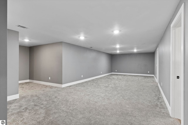 finished below grade area featuring carpet floors, recessed lighting, visible vents, and baseboards